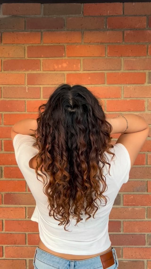Long curls with copper ends, back view after a curly haircut