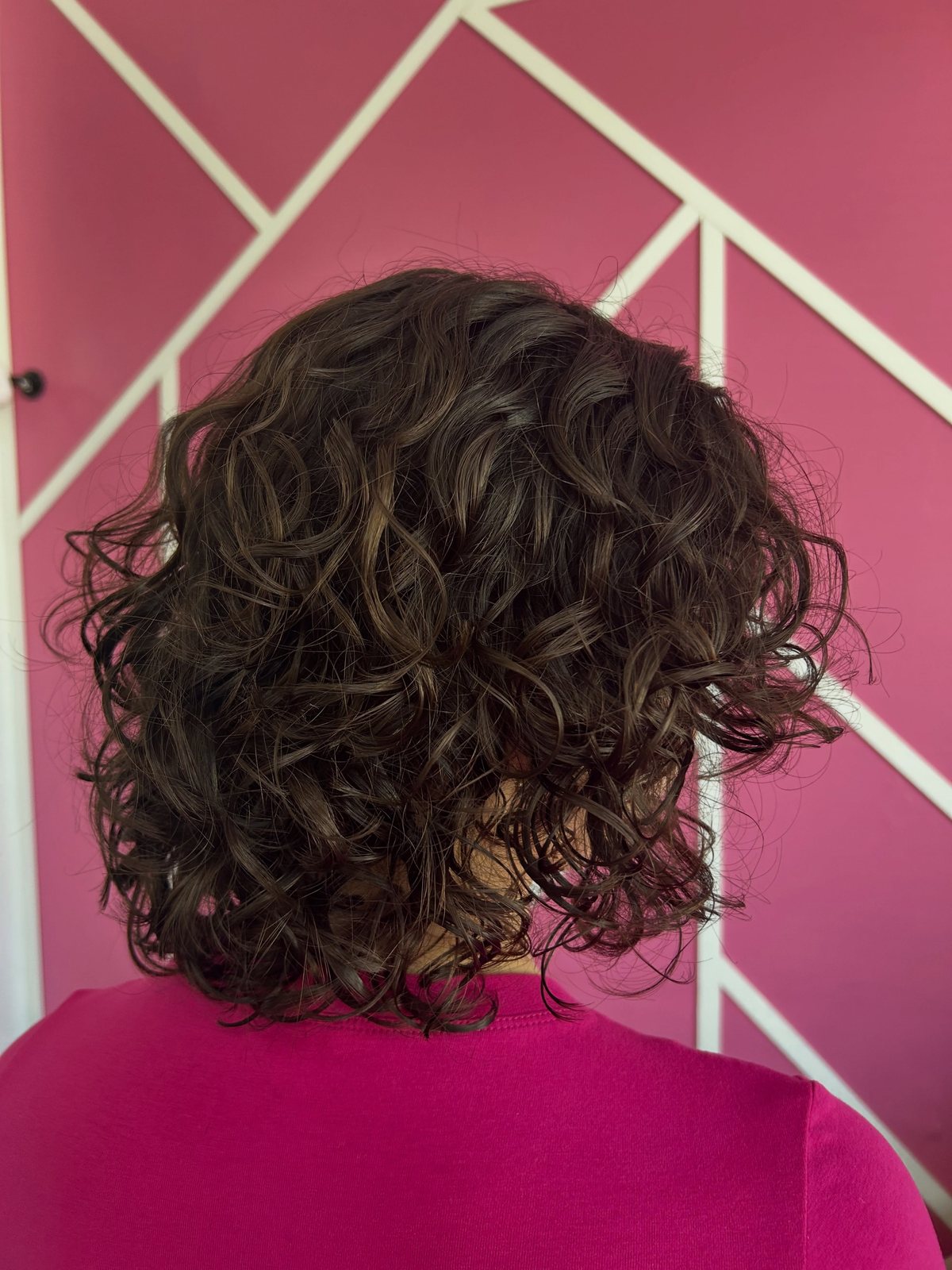 Shoulder-length shaped curls, back view, in the studio
